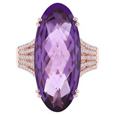 Elegant and exquisitely detailed 14 Karat Rose Gold Ring, Elongated Checkerboard Faceted Cabochon Oval Shape Amethyst weighing approx. 12.35Cts and micro pave set Diamond with approx. 0.38Cts Beautifully Hand crafted in 14 Karat Rose Gold Ring Stone Detail: Primary Stone: Amethyst Primary Stone Size: 28X12MM Primary Stone Cut: Cab Checker Primary Stone Shape: Oval Primary Stone Weight: 12.35Cts Approx Diamond GH/SI Total Diamond Weight: 0.38Cts Approx Once of our most Popular is this Stunning Am Elongated Oval, Amethyst And Diamond Ring, Cocktail Wedding, Ring Stone, Stone Cuts, Micro Pave, Amethyst Ring, Cocktail Rings, Oval Shape