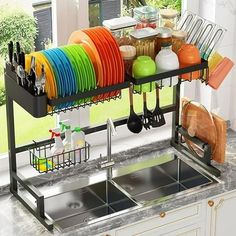 the dish rack is filled with dishes and utensils