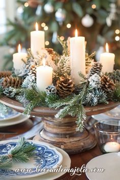 a christmas centerpiece with pine cones and candles