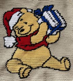 winnie the pooh crochet afghan with santa hat and snowflakes on it