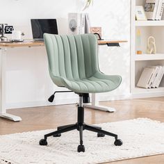 a green office chair sitting on top of a white rug in front of a desk