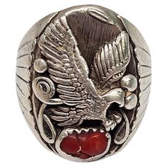 Sterling silver and coral ring by Native American artisan Richard Begay. Size 10 1/2 This sterling silver ring features a flying eagle with a red coral stone in a saw tooth bezel setting. Weighs approx 20.3g, 13.0dwt 1 1/8" high at front, stone measures approx 4mm x 8mm. Marked RB STERLING. Very nice condition with light tarnish and slight surface scratching. Will come packaged in a gift box or pouch (when possible) and will be shipped US Priority Mail with insurance. CL021324/17KCS Red Coral Stone, Vintage Native American Jewelry, Flying Eagle, Eagle Rock, Eagle Ring, Coral Ring, Silver Eagles, Ring Size 10, Coral Stone