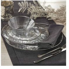 a place setting with silverware and napkins