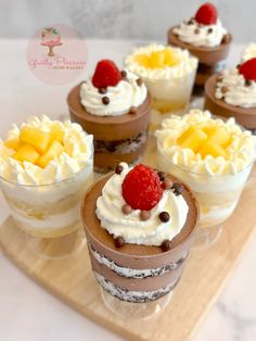 small desserts are arranged on a wooden tray