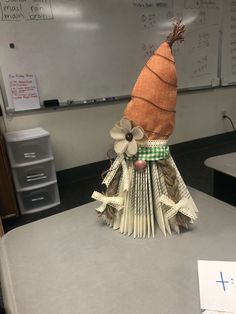 a carrot made out of books sitting on top of a desk