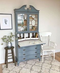 a desk and chair in a room with a white rug on the floor next to it