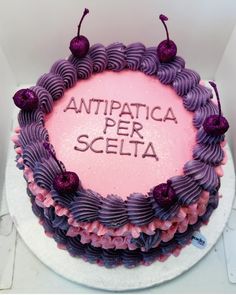 a cake with purple icing and writing on it that says antpatica per scelta