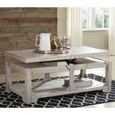 a coffee table with two trays on it and some glasses in front of it