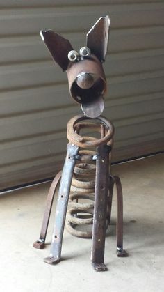 a metal dog sculpture sitting on top of a floor