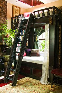 a bunk bed with a ladder in the middle of it and a window behind it