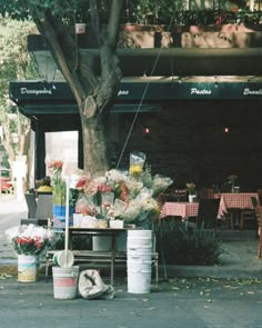 flowers and other items are on display outside the flower shop