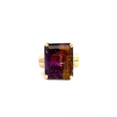 An ametrine solitaire ring.  Set in the center of the ring in a 4-prong setting is an emerald cut ametrine.  The ring has a cathedral style profile. This ring is a size 4.5.  This listing includes a sizing up or down 2 sizes.  Once a ring is re-sized, we guarantee the work but we are unable to offer a full refund on the ring. Please contact us for additional sizing options and expected ship date. Stone Information Type: Ametrine Measurements: 16.3x12.8mm Metal Content Guaranteed 10k yellow gold Weight: 10.0 grams Measurements of Ring 5/8 inches wide at top (16mm) 3/8 inches off finger (8mm) 3.1mm wide shank at bottom Markings 10k Amethyst Gemstones In Prong Setting - Yellow Gold, Yellow Gold Amethyst Cabochon Ring, Luxury Yellow Gold Multi-stone Amethyst Ring, 14k Gold Multi-stone Amethyst Ring, 14k Gold Multi-stone Purple Amethyst Ring, Emerald Cut, Style Profile, Solitaire Ring, Prong Setting