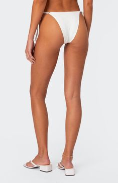 Online Only! Dive into summer with the Edikted Eyelet String Bikini Bottoms, your go-to for chic beach style! Featuring adjustable string ties for a customized fit and crafted from double-lined eyelet and stretch fabric blend of polyester and spandex, these bottoms offer both comfort and style. Whether you're lounging by the pool or catching waves at the beach, these bikini bottoms are sure to make a splash.


	Bikini bottom
	Adjustable string ties
	Double lined eyelet and stretch fabric
	Polyester, Spandex
	Model wears size XS
	Model height is 5'8
	Item care: Wash with similar color Summer Style Swimwear With String Tie, String Tie Swimwear For Poolside Summer, Beach Season Swimwear With String Tie, String Bottoms For Beach Season, Summer Stretch Swimwear With String Tie, Adjustable String Tie Swimwear For Beach Season, Adjustable Swimwear With Side Ties For Poolside, String Bottoms For Poolside And Beach Season, Adjustable String Tie Swimwear For Swimming