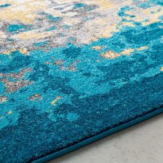 a blue rug with yellow and gray designs on it