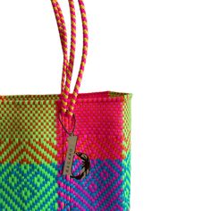 a multicolored bag with a handle on the front and side, sitting against a white background