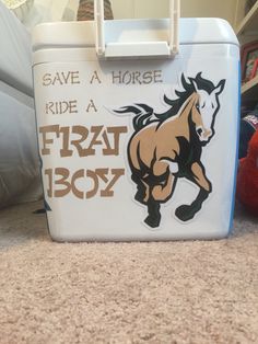 a cooler with a horse on it sitting on the floor next to a stuffed animal