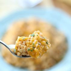 a spoon full of food on top of a blue plate