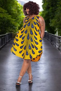 Introducing the Dupsie's African Fashion "Ajere Peacock Dress" — A Celebration of African Heritage and Modern Style! Step into a world where tradition meets contemporary elegance with our Ajere Peacock Wrap Dress. This stunning piece showcases a vibrant Orange and Royal Blue Bulb Peacock African Print and is crafted from high-quality cotton Ankara fabric, ensuring both comfort and style. Our dress is designed for the modern woman who values authentic African fashion while embracing her individua African Dashiki Shirt, African Tops For Women, Modern African Clothing, African Pants, African Shoes, African Hats, Dashiki Shirt, African Tops, Head Wraps For Women