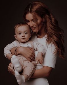 a woman holding a baby in her arms