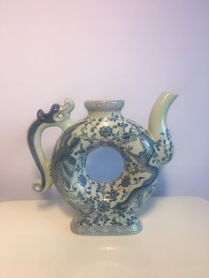 a blue and white vase sitting on top of a table