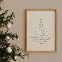 a christmas tree next to a framed poem