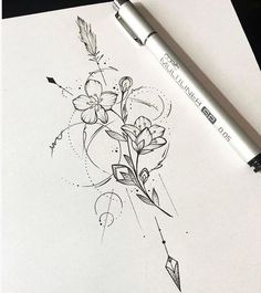 a drawing of flowers and arrows on paper with a pen next to it, which is also in color