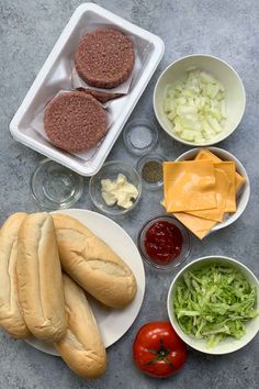 the ingredients are laid out on the table to make burgers and salads for lunch