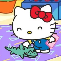 the hello kitty is holding an alligator in her hand