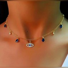 New Stunning Gold Evil Eye Necklace W/Blue Hanging Gems/Gemstones/Crystals/Beads That Will Make You Stand Out From The Crowd! Features Evil Eye/Devil's Eye Rhinestone/Cubic Zirconia/Cz Diamond Hanging Pendant Charm That Sparkles & Shines W/Every Movement. The Evil Eye Is A Symbol Of Protection & Good Luck In Many Cultures & This Necklace Will Bring You Both! The Blue Hanging Gemstones Add A Touch Of Color & Elegance To The Necklace. Perfect For Any Occasion, Whether You Want To Dress Up A Casual Blue Jeweled Necklace For Gift, Gold Evil Eye Necklace, Grecian Goddess, Evil Eye Necklace Gold, Chocker Necklace, Handcrafted Necklace, Faux Pearl Necklace, Evil Eye Necklace, Glass Bead Necklace