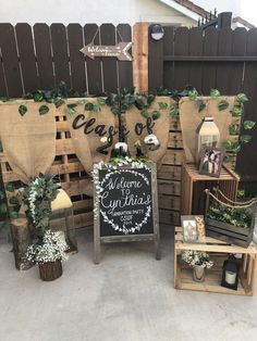 several wooden crates with plants on them and a chalkboard sign that says welcome to our guests