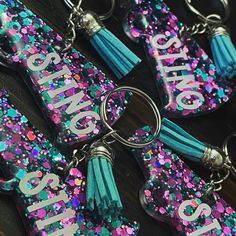 several keychains with the word class on them and tassels attached to them