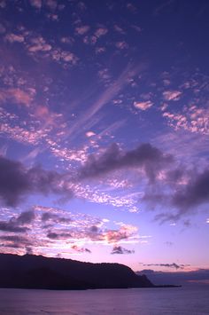 the sky is purple and blue with some clouds