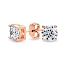 two pairs of diamond stud earrings in yellow gold