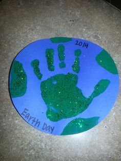 a blue and green handprint with the words earth day on it