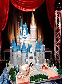 an elaborate castle cake is displayed on a table