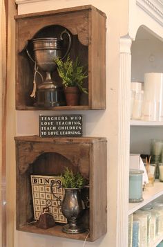 two wooden boxes with plants in them on the wall