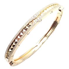 Authentic! Bulgari Bvlgari B.Zero1 Rock 18k Yellow Gold Diamond Bangle Bracelet Welcome to Fortrove Payment / Shipping / Returns STORE HOME About Us NEW ARRIVALS ENDING SOON Add to Favorites FEEDBACK Contact Us Authentic! Bulgari Bvlgari B.Zero1 Rock 18k Yellow Gold Diamond Bangle Bracelet Product Description About This Piece: The Bulgari B.Zero1 Rock 18k Yellow Gold Diamond Bangle Bracelet exudes luxury and elegance. Featuring a bold design, it's crafted from 18k yellow gold and adorned with brilliant diamonds.  This iconic piece combines contemporary flair with classic sophistication, making it a statement accessory for any occasion. Retail Price of this bracelet is $20,900 Metal: 18k Yellow Gold Width:  Weight: 6mm 34.1 grams Size: Medium 6.7" or 17cm Stones: 320 brilliant cut diamonds Trinity Bracelet, Chanel Ring, Diamond Bangle Bracelet, Indian Jewellery Design Earrings, Diamond Bangles Bracelet, Jewelry Design Earrings, Fine Jewelry Bracelets, Gold Bangle, Diamond Bangle