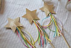 gold stars and streamers on a table with confetti sticks in the foreground