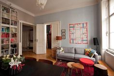 a living room filled with furniture and lots of bookshelves on top of it