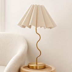 a lamp on a table next to a chair