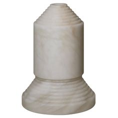 a white marble vase sitting on top of a table