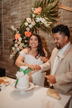 a bride and groom cutting their wedding cake