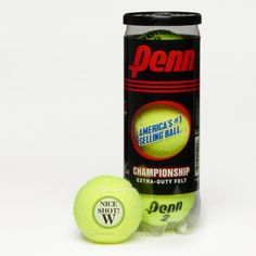 two tennis balls next to a can of demn