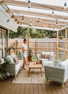 an outdoor living area with couches, chairs and a coffee table on the deck