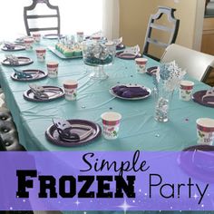 a frozen party table set up with plates and cups