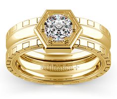 a wedding ring set with a diamond in the center and two bands on each side