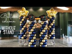 balloon columns with gold, blue and white balloons in the shape of stars are on display