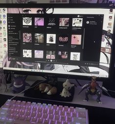 a computer monitor sitting on top of a desk next to a purple keyboard and mouse