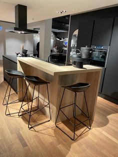 two stools sit at the center of a kitchen island