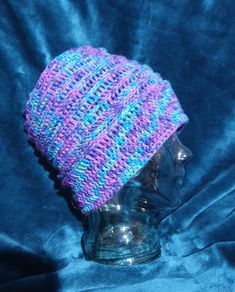 This is a small to medium adult sized, unisex, hand crocheted slouch hat made in easy care acrylic yarn in gorgeous tones of purple,  blue and green. A stylish hat to wear in the change of seasons.  Made with lovely and easy care acrylic yarn. Please note there may be variations in the actual colour due to photography.  The hat measures approximately 54cm x 25cm. Sized to fit small to medium - Adult. There is some stretch in the hat. Pattern is courtesy of Fibre flux.  There is a matching pair o Purple Crochet Yarn Hat, Adjustable Purple Crochet Hat, Adjustable Purple Hand Knitted Crochet Hat, Purple Crochet Hat One Size, Purple Hand Knitted Crochet Hat, Purple Crochet Hat One Size Fits All, Adjustable Hand Knitted Purple Crochet Hat, Adjustable Hand-knitted Purple Crochet Hat, Hand Knitted Purple Crochet Hat One Size Fits Most